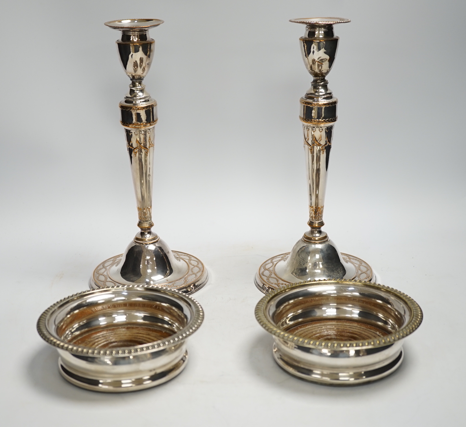 A pair of 19th century silver plated candlesticks and a pair of coasters, tallest 28cm